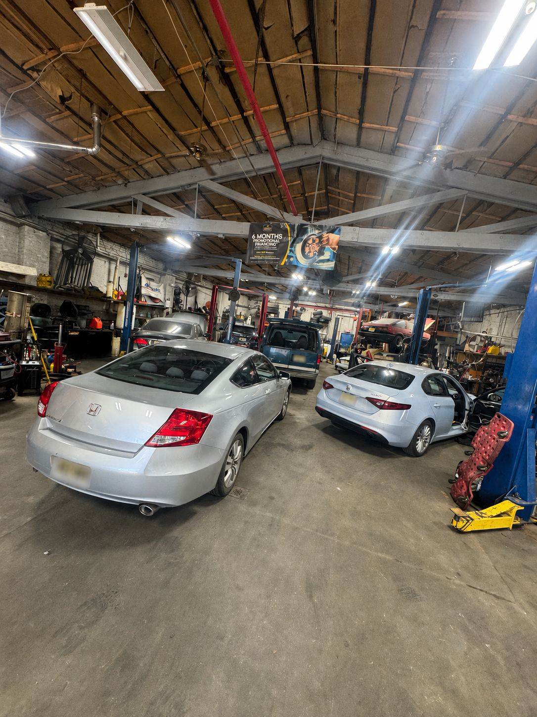 Vehicles being serviced inside the Ortega Auto Service shop