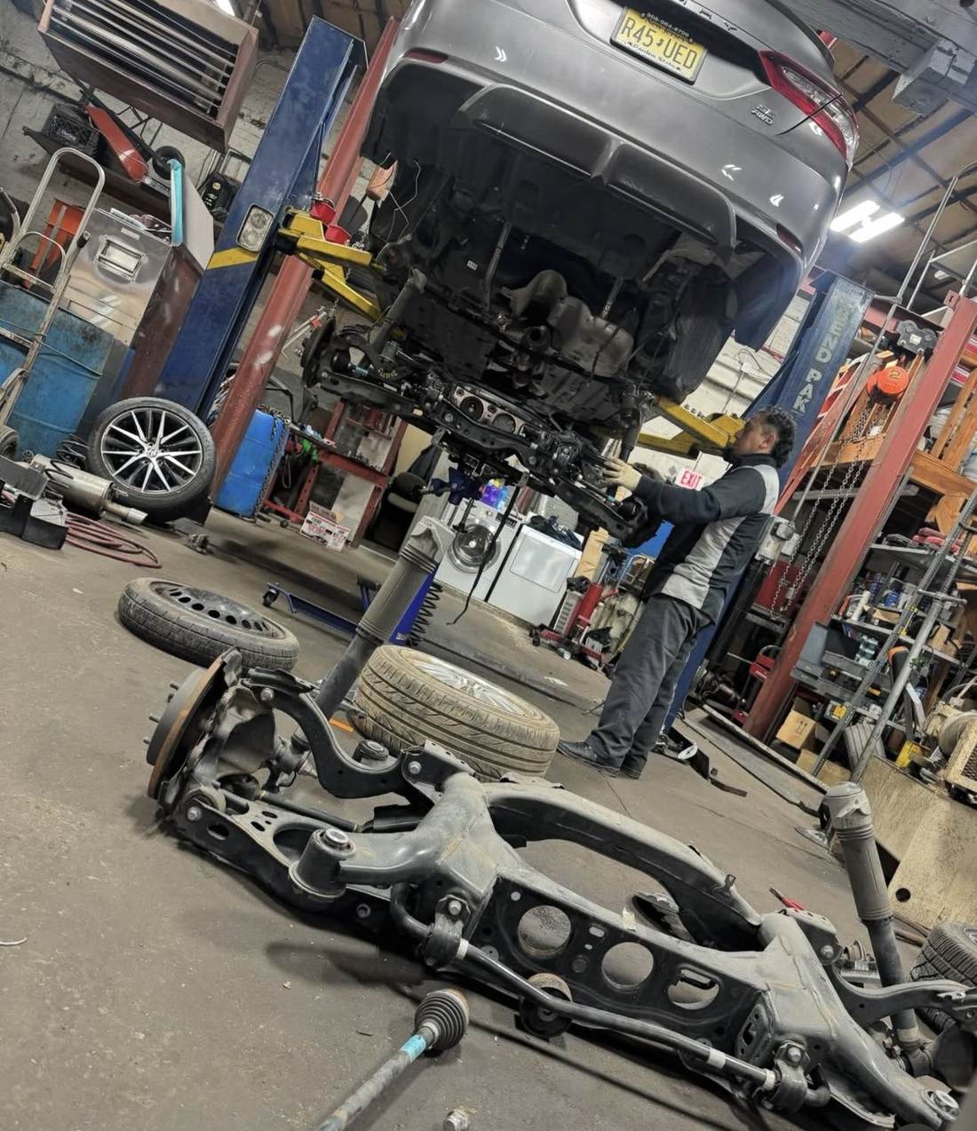 Technician performing suspension repair at Ortega Auto Service