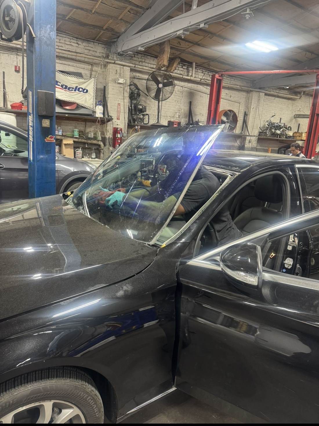 Technician performing windshield and body repair at Ortega Auto Service